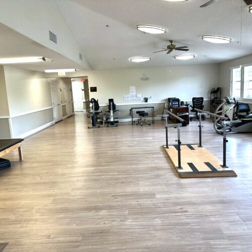 Community fitness center with vinyl floors and workout equipment